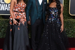 Idris Elba walks the red carpet with his fiancee, Sabrina Dhowre, and his daughter, Isan. Isan, right, is a Golden Globes ambassador this year