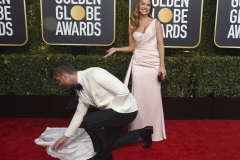 Justin Hartley adjusts the dress of his wife, Chrishell Stause