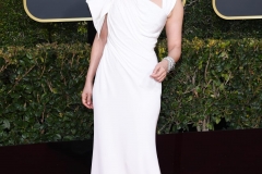 Sandra Oh channeled vintage Hollywood glamour with side-swept curls and red lips. She wore a draped ivory dress by Versace.
